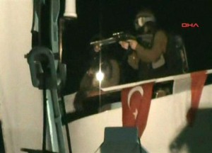 Israel Palestinians This video image released by the Turkish Aid group IHH Monday May 31, 2010 purports to show Israeli soldiers aiming a gun on the deck of a Turkish ship, part of an aid convoy heading to the Gaza Strip, after Israeli soldiers boarded the vessel in international waters off the Gaza coast. Israeli commandos on Monday stormed six ships carrying hundreds of pro-Palestinian activists on an aid mission to the blockaded Gaza Strip, killing at least 10 people and wounding dozens after encountering unexpected resistance as the forces boarded the vessels. AP Photo/IHH via APTN)