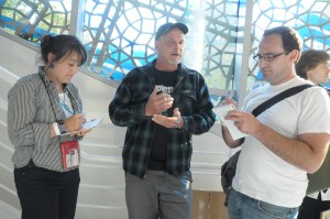 Fog City Journal reporters Catherine Lee and Brian Rinker talk to artist Chuck Sperry (center) on July 14, 2012 at the Occupy Bay Area art show at Yerba Buena Center for the Arts in San Francisco. Photo by Shane Menez