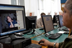 Irma Garcia, 45, visits the Library in South San Francisco on Tuesday (Feb.28). She logs on to her Facebook and looks through pictures of herself from four years ago when she was in a much better situation and not living on the streets. "This is when I had teeth" says Garcia. Photo by Jessica Worthington