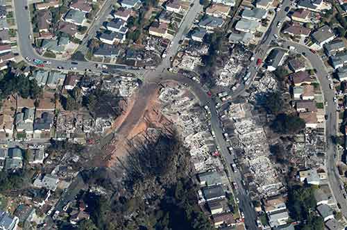 An aerial photo shows the destruction of the Crestmoor residential neighborhood in the City of San Bruno neighborhood following a September 9 PG&E gas pipeline explosion.  Eight people were killed as a result of the explosion and inferno.  Photo via FEMA.