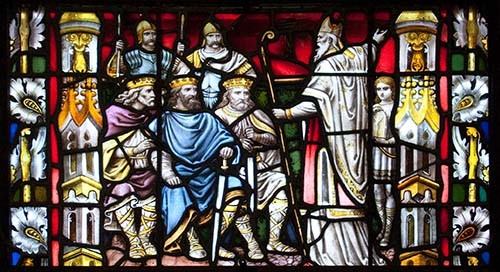Bottom feature of the center stained glass window in the north transept of Carlow Cathedral of the Assumption, showing St Patrick Preaching to the Kings. Created by Franz Mayer & Co. in the 19th century. Photo via commons.wikimedia.org.